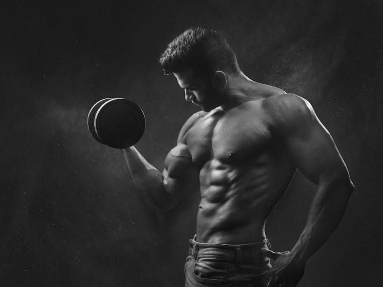 Man Holding Black Dumbbell