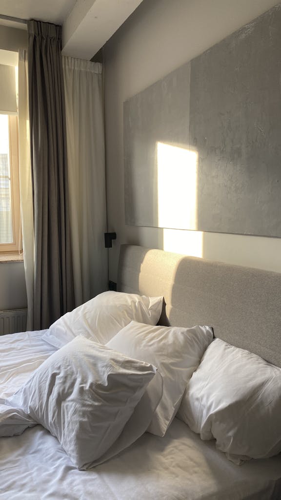 White Bed Linen and Pillows in a Bedroom