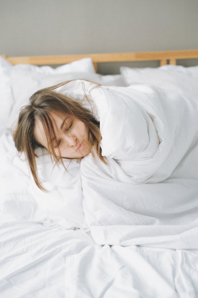 Woman Covered in White Blanket Lying on Bed - The Power of Sleep