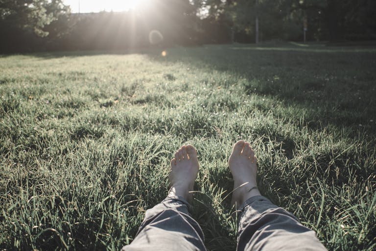 Photo of Person Sitting on Grass Field